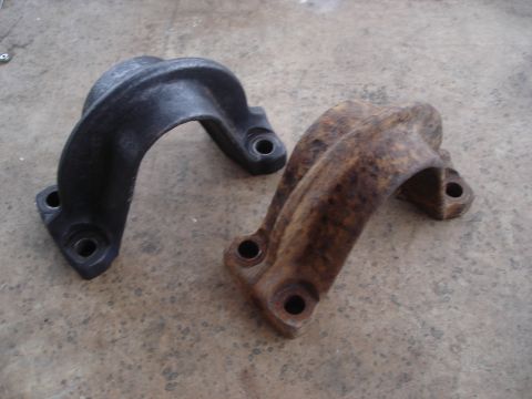 1990 Ford Bronco - Comparison of a black metal bracket and a rusted bracket, both with mounting holes.