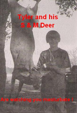 2000 Ford Crown Victoria - A deer is shown hanging from a tree, with a person standing nearby.