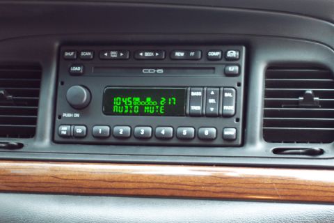 2001 Ford Crown Victoria - Interior of a 2001 Ford Crown Victoria, showing the radio and wood grain dashboard trim.