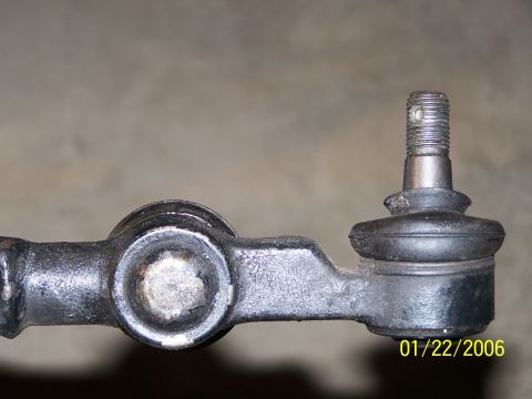 1988 Suzuki Samurai - A close-up view of a vehicle's steering linkage component, showing a ball joint assembly.