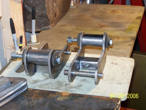 1988 Suzuki Samurai - Custom suspension shackles are shown on a workbench, ready for installation.
