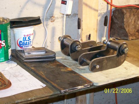 1988 Suzuki Samurai - Custom shackle lift components are laid out on a workbench next to a U.S. Coast coffee can.
