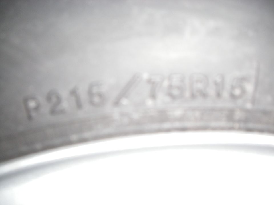 Close-up of tire sidewall size lettering reading P215/75R15