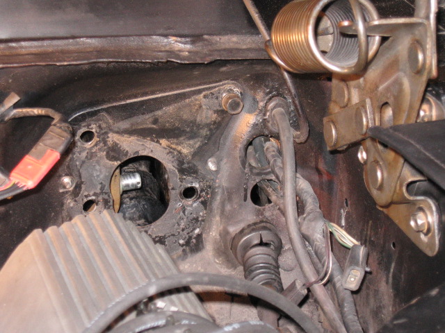 Close-up of car firewall with brake pedal mechanism and wiring