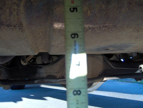 1978 Ford Bronco - Measuring undercarriage clearance with a tape measure.