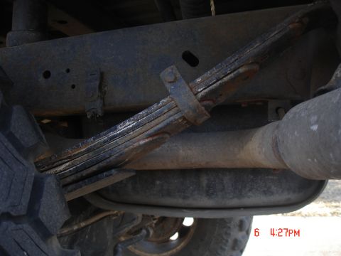 1979 Ford Bronco - Underside view of a vehicle's leaf spring suspension and exhaust system.