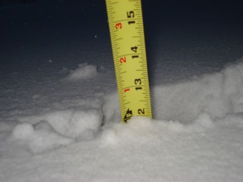 1998 Ford Taurus - A tape measure is used to gauge snow depth, indicating about 13 inches of accumulation.