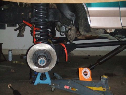 1996 Ford Bronco - Front suspension and brake assembly of a 1996 Ford Bronco undergoing work.
