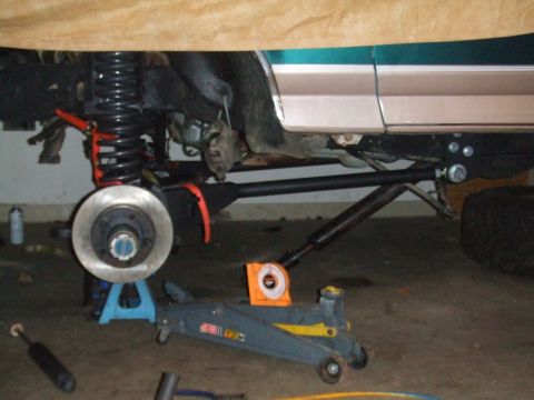 1996 Ford Bronco - Vehicle is on jack stands with suspension components being worked on.