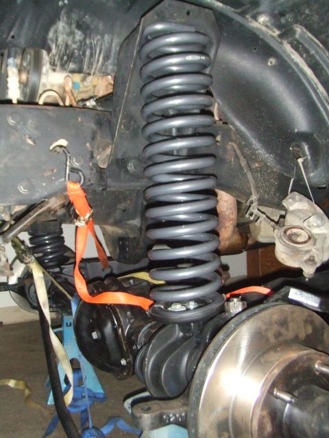 1996 Ford Bronco - Vehicle suspension components, including a coil spring and brake assembly, are shown during a repair or modification.