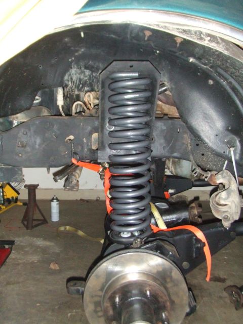 1996 Ford Bronco - The vehicle's front suspension and brake assembly is shown during a repair or upgrade process.