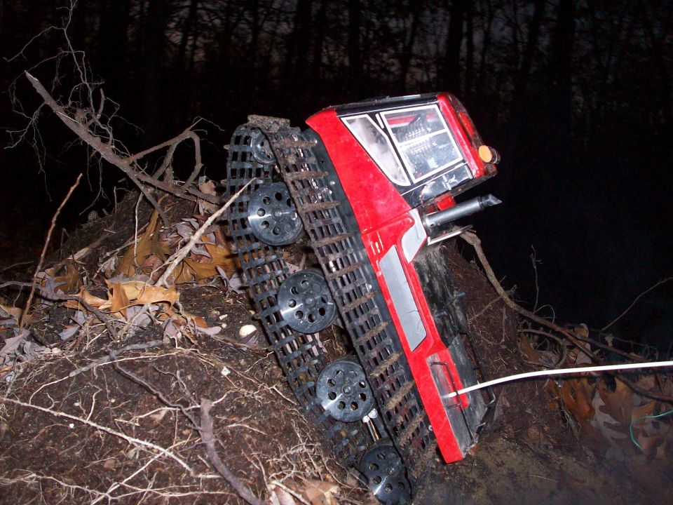 Red tracked vehicle on uneven terrain