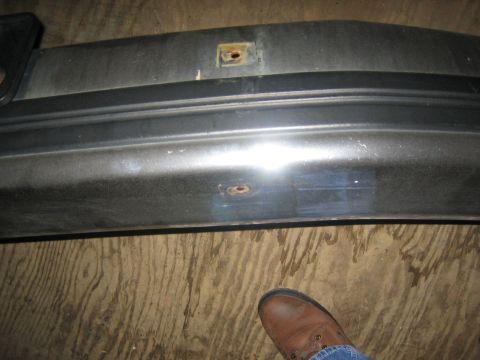 1994 Ford Bronco - A close-up view of a vehicle bumper part, showing some wear and tear.