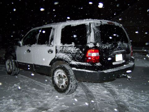 2004 Ford Expedition - Rear view of a Ford Expedition parked in the snow at night.