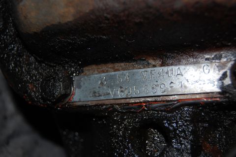 1994 Ford Bronco - VIN plate shows '54' indicating a 1954 model year, not 1994. The plate is attached to a greasy mechanical part.