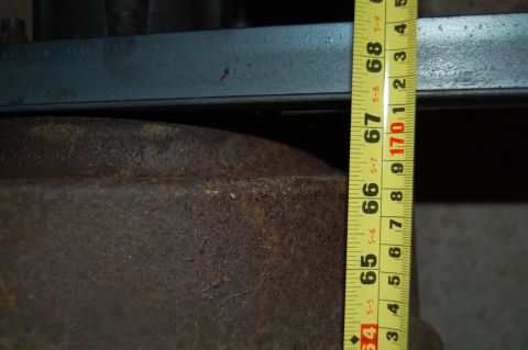 1994 Ford Bronco - A measuring tape is used to gauge the size of a rusty axle component, with readings from 65 to 68 inches visible.