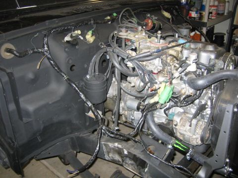 1987 Suzuki Samurai - Close-up view of the engine bay wiring harness, showing the carburetor and distributor components.