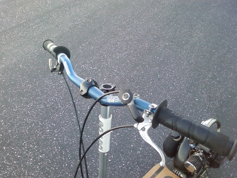 Blue handlebars with black grips and brake lever on a scooter