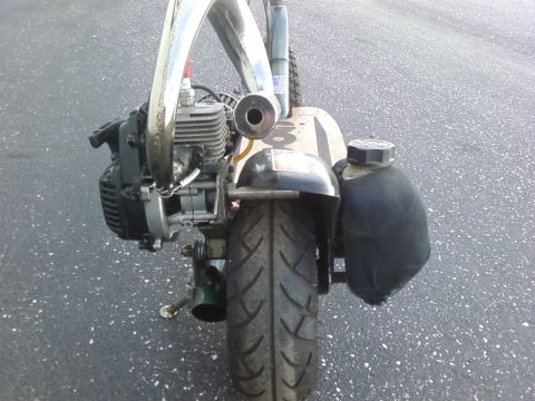 1995 Ford Bronco - Go-ped scooter rear view with engine and exhaust pipe visible.