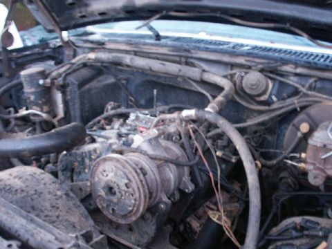 1984 Ford Bronco - The engine bay of a vehicle, showing various components and wiring.