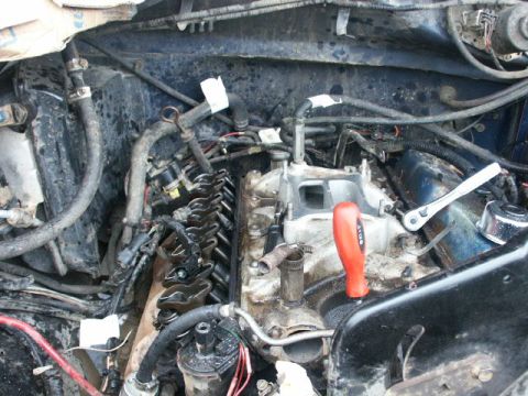 1984 Ford Bronco - Close-up view of an engine with the valve covers off, revealing the rocker arms and pushrods.
