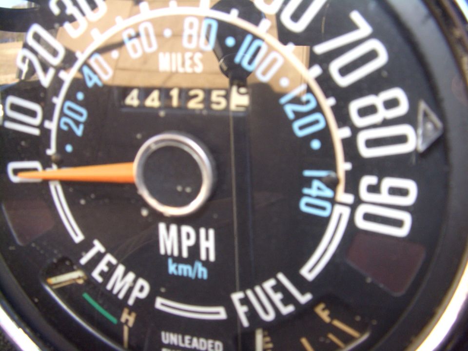 Round speedometer gauge reading 44125 miles