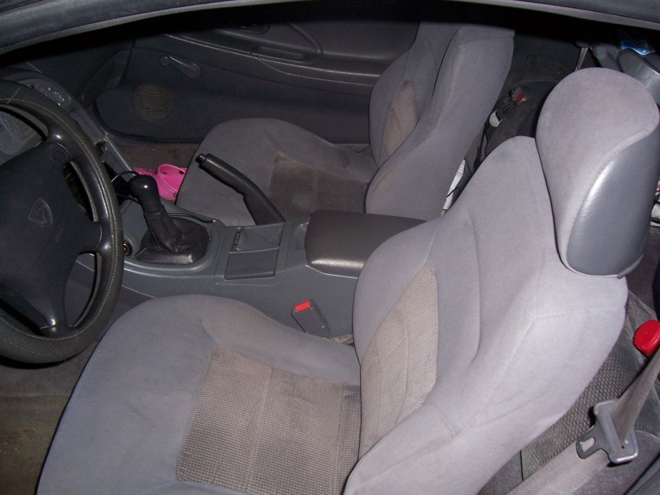 Gray cloth front bucket seats and center console of a coupe interior