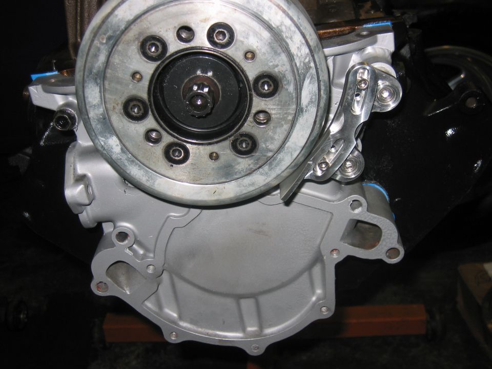 Engine water pump housing and pulley assembly, silver and black metal components