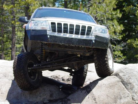 1999 Jeep Grand Cherokee - This Jeep Grand Cherokee navigates rocky terrain with its front wheels elevated.