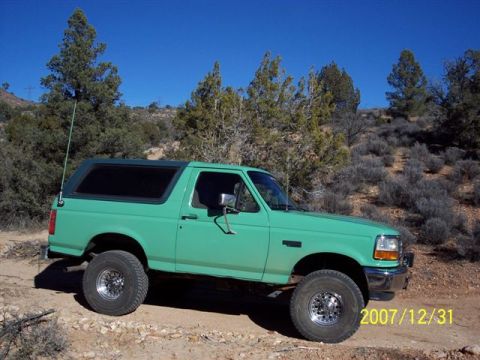 1996 Ford Bronco - This 1996 Ford Bronco is shown in a desert-like environment under a clear blue sky.