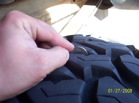 1995 Ford Bronco - Measuring tire tread depth with a quarter.