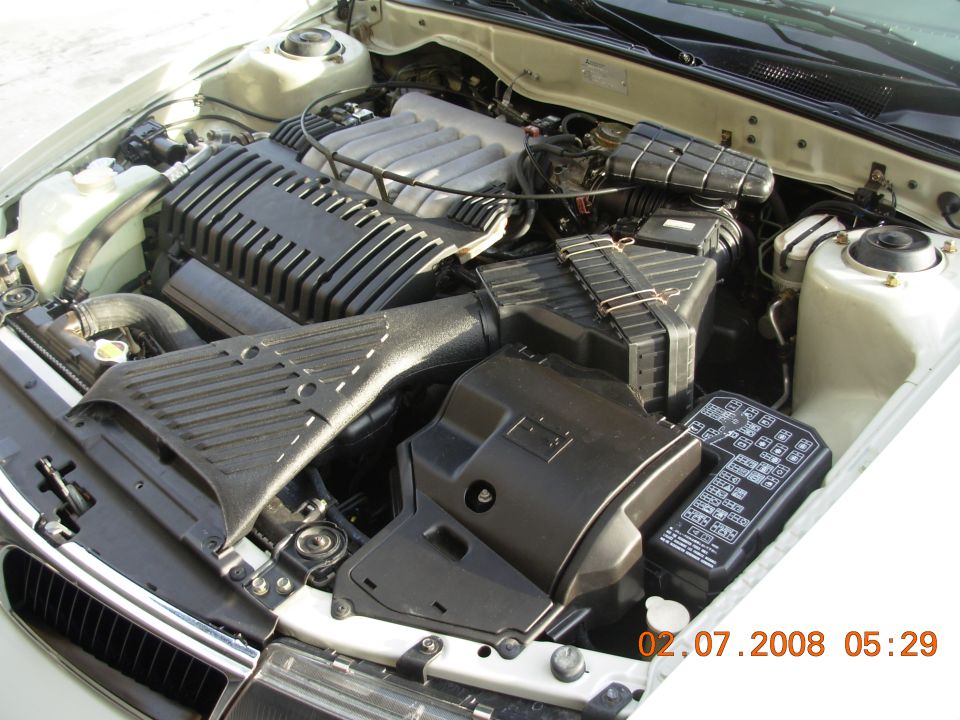Engine bay with V6 engine cover and fuse box. Date stamp 02.07.2008