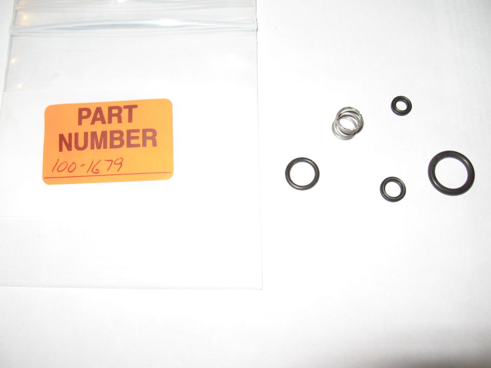 Black O-rings and metal spring beside a bag labeled PART NUMBER 100-1679
