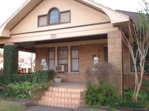 1996 Ford Taurus - A house's front porch features brickwork, stairs, and decorative lion statues flanking the entrance.