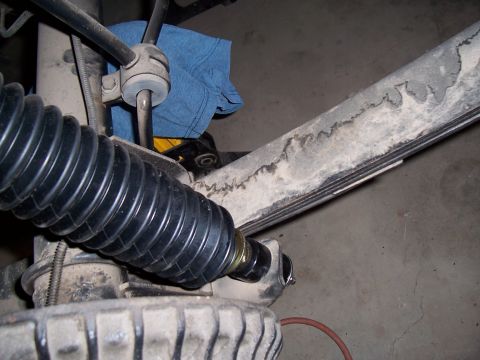 1979 Chevrolet Camaro - Detail shot of a vehicle's suspension system, showing a steering bellows and leaf spring.