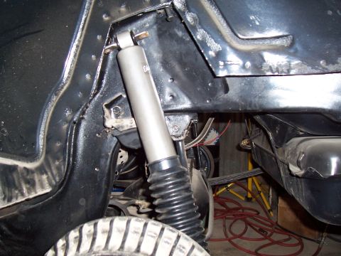 1979 Chevrolet Camaro - A detailed view of a vehicle's suspension system, showing a shock absorber and tire tread.
