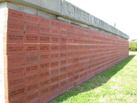 1997 Ford Crown Victoria - Engraved bricks form a memorial wall under a concrete structure with text.