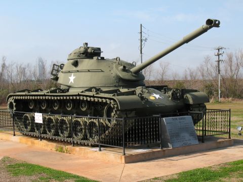 1997 Ford Crown Victoria - This military tank is on display at a park, with a plaque providing information about its history.