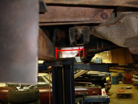 1993 Ford Bronco - Close-up view of a vehicle's undercarriage, showing suspension components and a measurement guide.