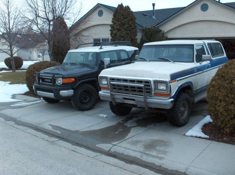 2008 Toyota FJ Cruiser - Two SUVs, a Toyota FJ Cruiser and a Ford Bronco, are parked in a driveway during winter.