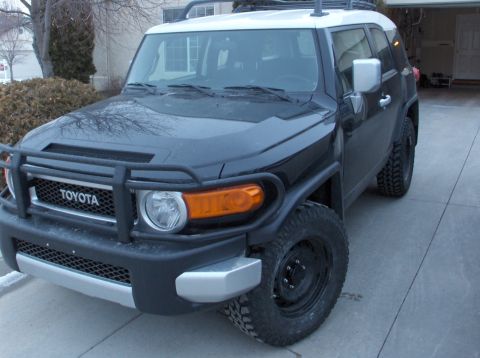 2008 Toyota FJ Cruiser - This black 2008 Toyota FJ Cruiser features a white roof and a prominent front brush guard.