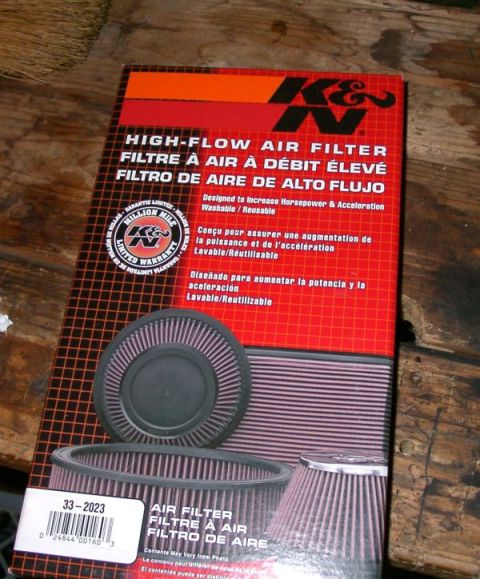 1994 Ford Bronco - K&N High-Flow Air Filter box with part number 33-2023 shown on a wooden surface.