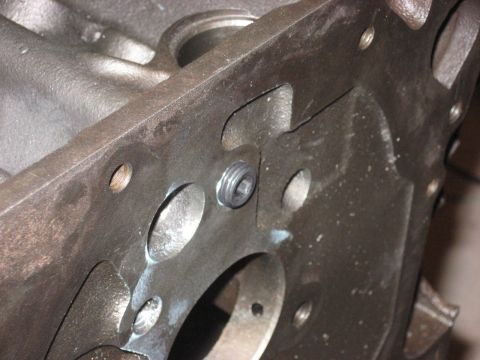 1965 Ford Galaxie - A close-up view of a cast iron engine block shows a hex-head plug with visible threads.