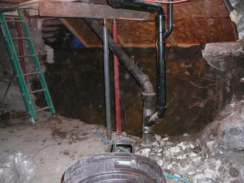 1997 Mercury Grand Marquis - A view of a house foundation showing exposed dirt, plumbing pipes, and a ladder.
