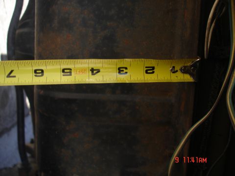 1979 Ford Bronco - A close-up shows a measuring tape against a dark, cylindrical surface.