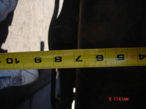 1979 Ford Bronco - A yellow measuring tape is shown against a dark background, with markings indicating measurements.