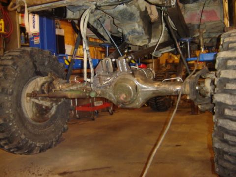 1992 Ford Bronco - Close-up view of a vehicle's rear axle and suspension components in a workshop setting.