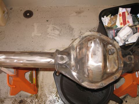 1995 Ford Bronco - A vehicle's rear axle differential is shown supported by jack stands in a garage setting.