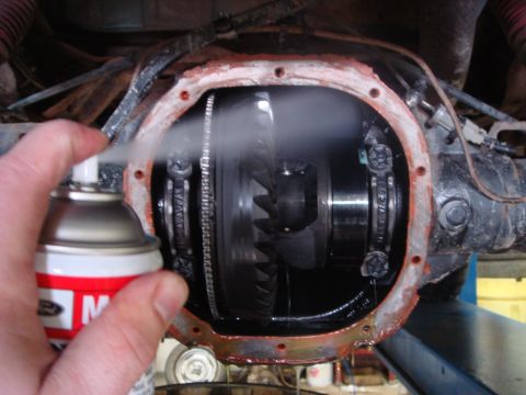 1996 Ford Bronco - Brake cleaner is sprayed into the differential housing during a fluid change procedure.