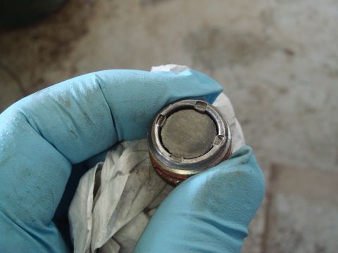 1996 Ford Bronco - Oil drain plug removed, showing accumulated metal shavings from the engine.
